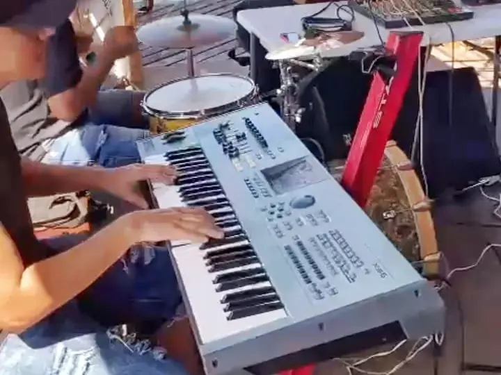 Keyboard player performing live on board