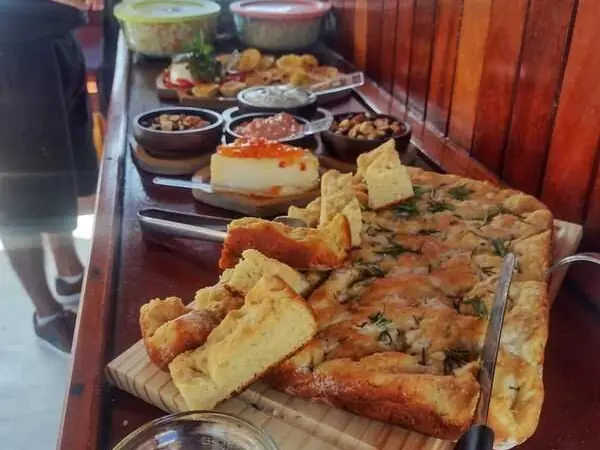 Staff serving tartlets and bites at the onboard bar