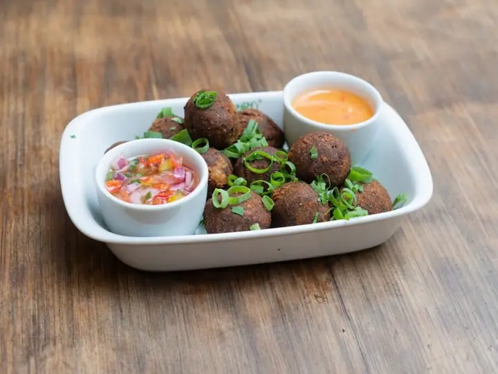 Feijoada croquettes with dips on a white dish