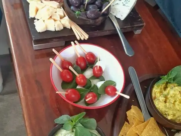 Cheese board, cherry tomatoes and bites on the onboard table