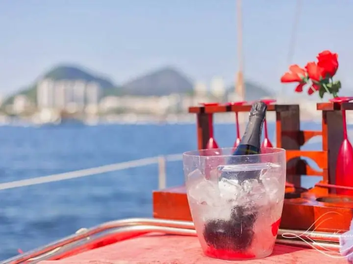 Sparkling wine on ice and flowers on the bow, with Rio’s waterfront behind